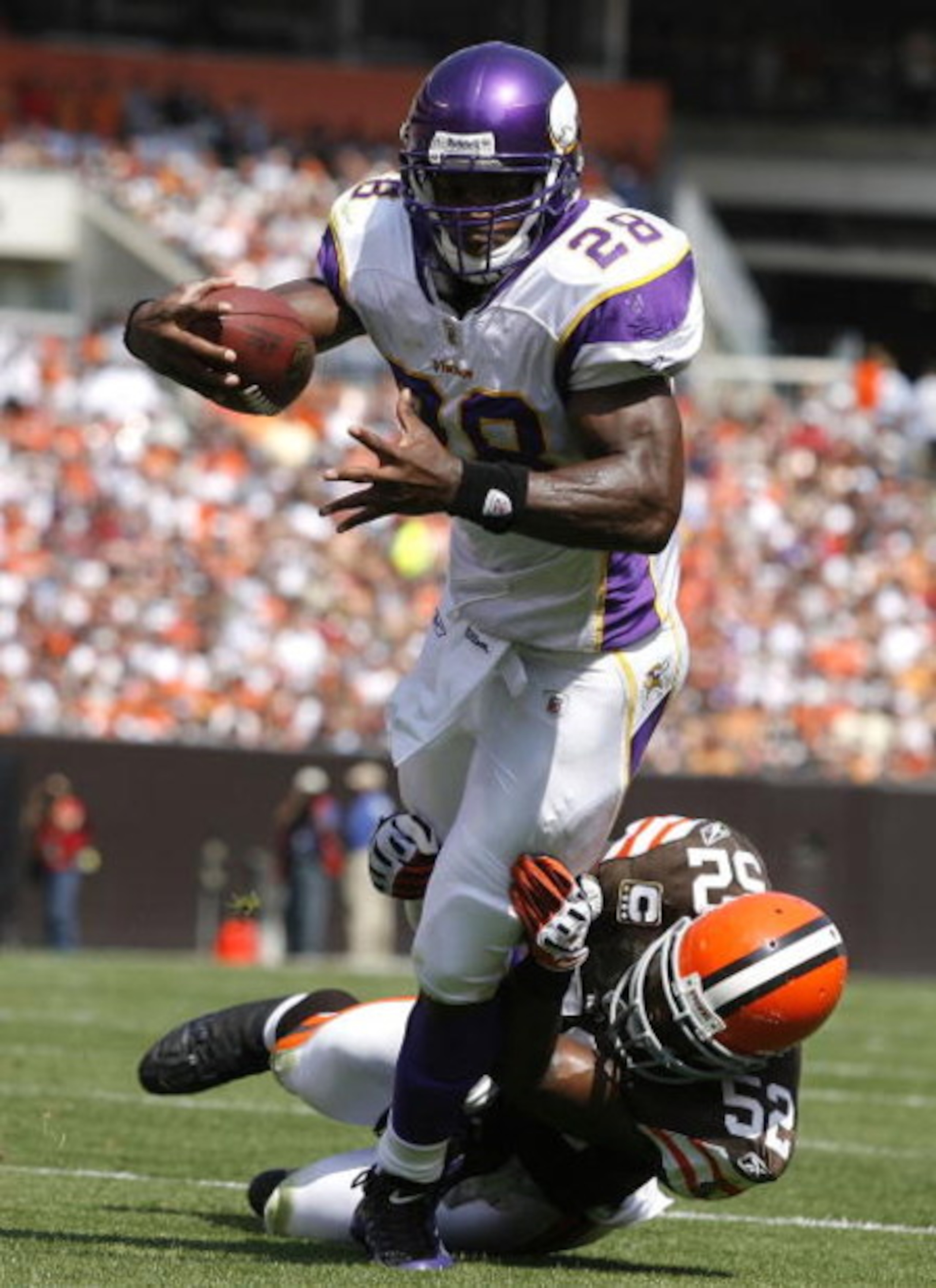 CLEVELAND - SEPTEMBER 13:  Adrian Peterson #28 of the Minnesota Vikings is hit by D'Qwell Jackson #52 of the Cleveland Brwons at Cleveland Browns Stadium on September 13, 2009 in Cleveland, Ohio.  (Photo by Matt Sullivan/Getty Images)