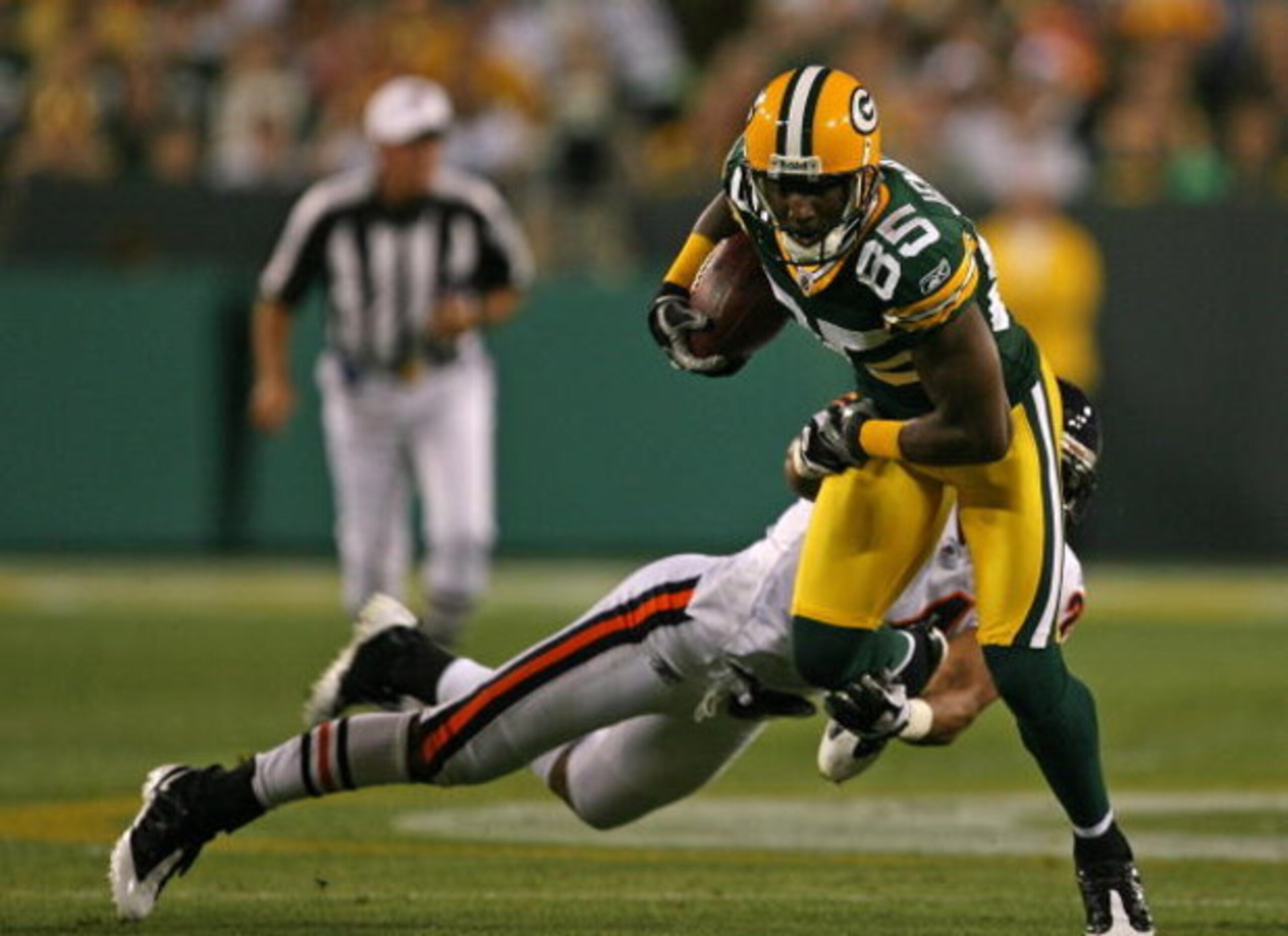 GREEN BAY, WI - SEPTEMBER 13: Greg Jennings #85 of the Green Bay Packers breaks away from Al Afalava #24 of the Chicago Bears on September 13, 2009 at Lambeau Field in Green Bay, Wisconsin. (Photo by Jonathan Daniel/Getty Images)