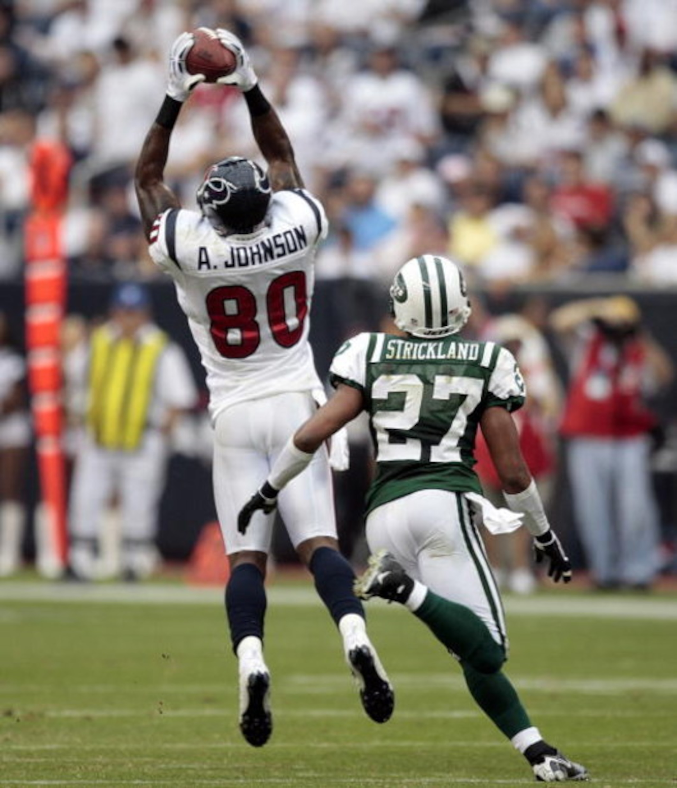 HOUSTON - SEPTEMBER 13:  Wide receiver Andre Johnson #80 of the Houston Texans makes a reception in front of cornerback Donald Strickland #27 of the new York Jets at Reliant Stadium on September 13, 2009 in Houston, Texas.  (Photo by Bob Levey/Getty Image