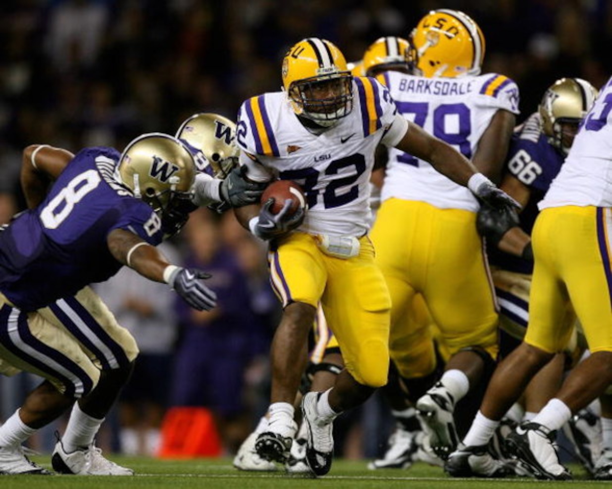 SEATTLE - SEPTEMBER 05:  Running back Charles Scott #32 of the LSU Tigers rushes against Nate Williams #8 of the Washington Huskies on September 5, 2009 at Husky Stadium in Seattle, Washington. The Tigers defeated the Huskies 31-23. (Photo by Otto Greule 