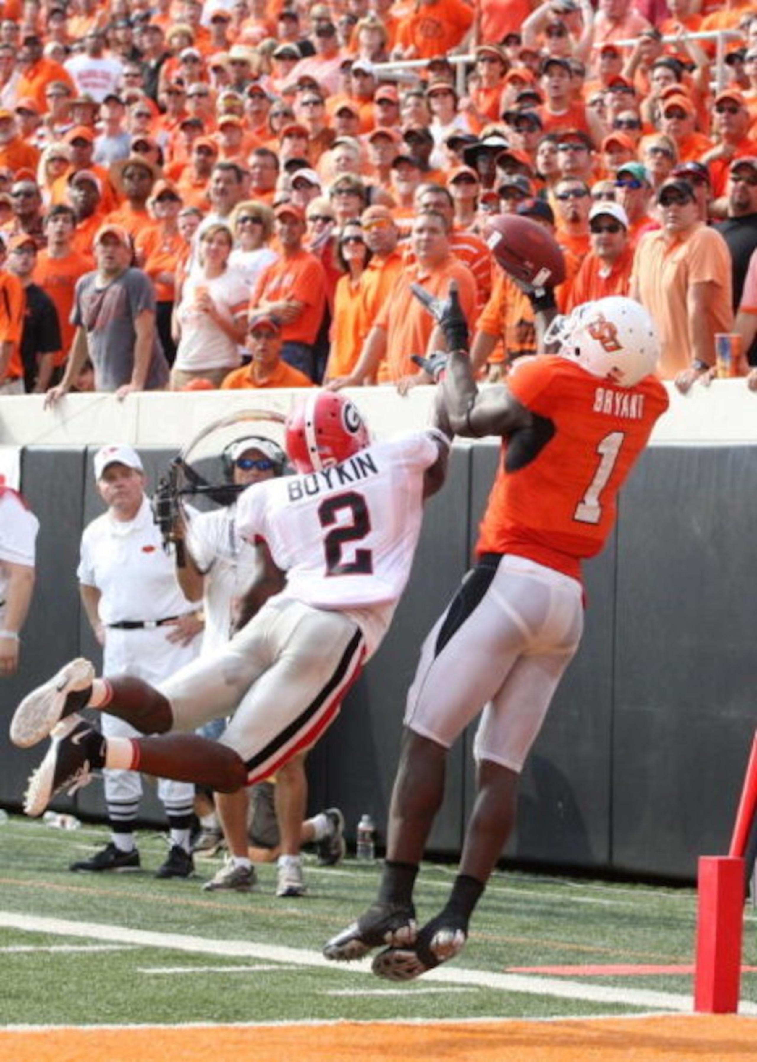 STILLWATER, OK - SEPTEMBER 5: Runningback Brandon Boykin #2 of the Georgia Bulldogs dives for the ball for the ball as Dez Bryant #1 of the Oklahoma State Cowboys cannot make the pass during the third quarter of the game at Boone Pickens Stadium on Septe STILLWATER, OK - SEPTEMBER 5: Runningback Brandon Boykin #2 of the Georgia Bulldogs dives for the ball for the ball as Dez Bryant #1 of the Oklahoma State Cowboys cannot make the pass during the third quarter of the game at Boone Pickens Stadium on Septe