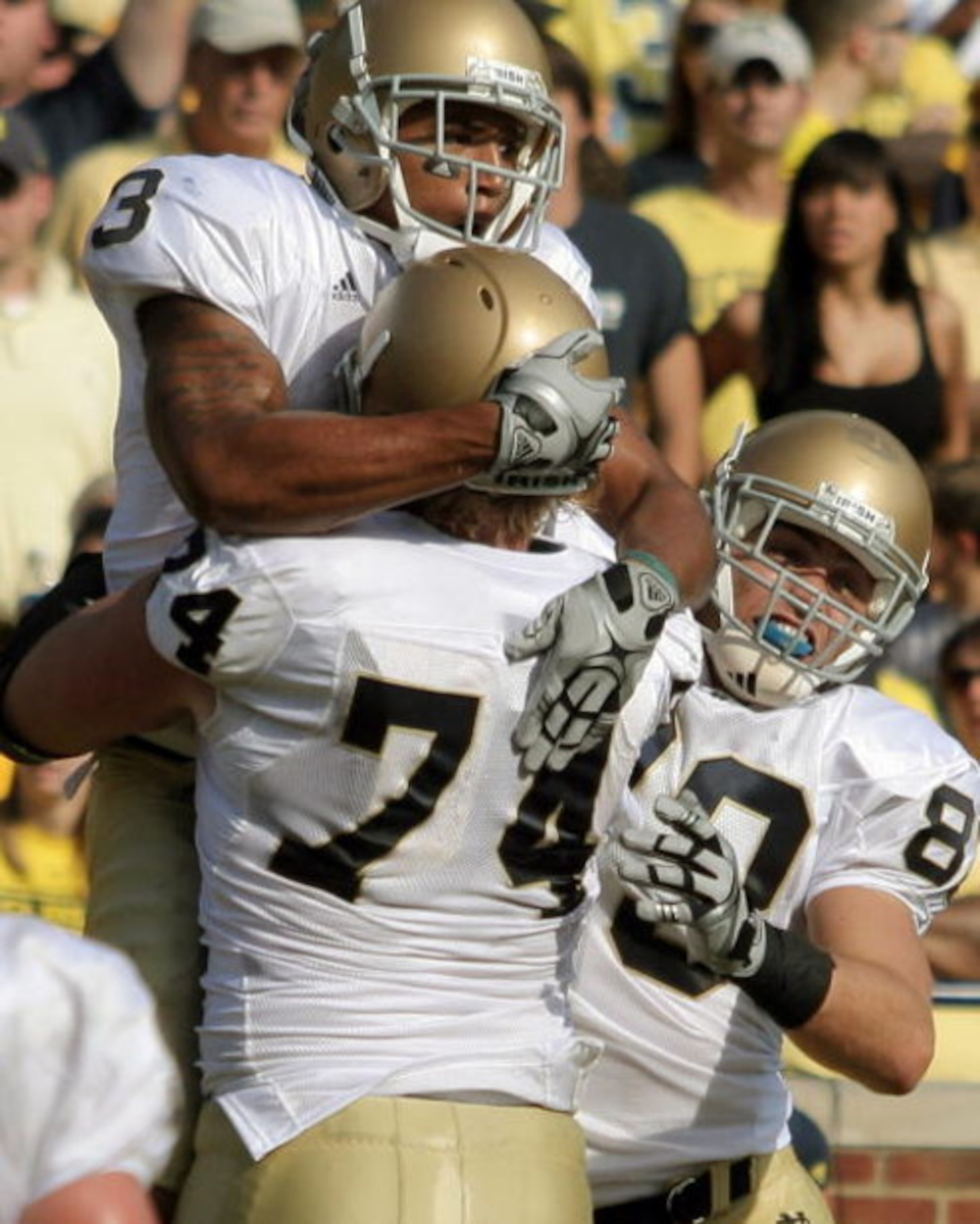 ANN ARBOR, MI - SEPTEMBER 12:  Wide receiver Michael Floyd #3 of Notre Dame celebrates with teammates Sam Young #74 and Tyler Eifert #80 after catching a touchdown pass in the second quarter to put his team ahead 17-14 against Michigan at Michigan Stadium