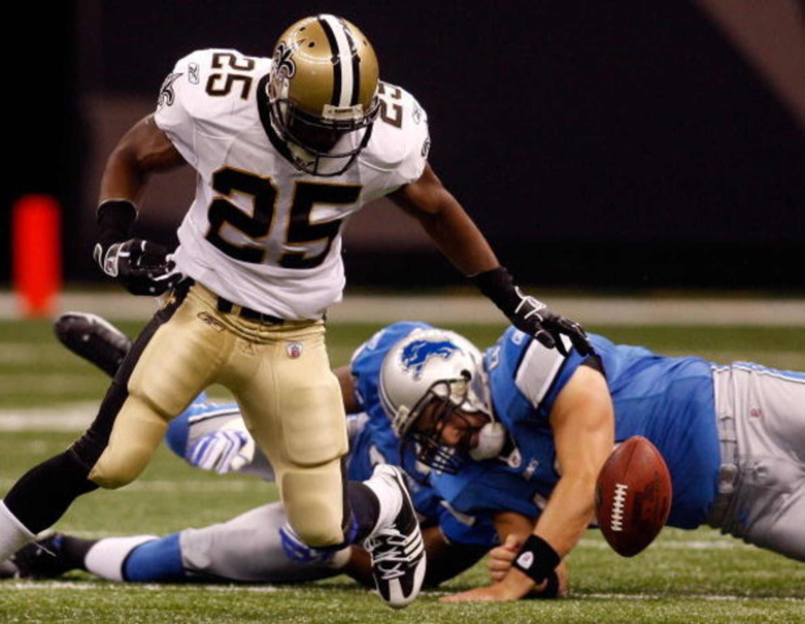 NEW ORLEANS - SEPTEMBER 13:  Reggie Bush #25 of the New Orleans Saints fumbles the ball as he is tackled by Don Muhlbach #48 of the Detroit Lions at the Louisiana Superdome on September 13, 2009 in New Orleans, Louisiana.  (Photo by Chris Graythen/Getty I