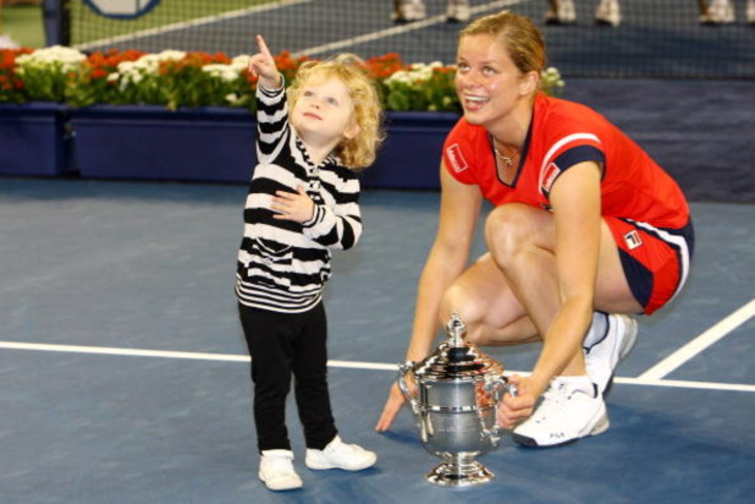 NEW YORK - SEPTEMBER 13: Kim Clijsters of Belgium and daughter Jada pose with the championship trophy after Clijsters defeated Caroline Wozniacki of Denmark in the Women�s Singles final on day fourteen of the 2009 U.S. Open at the USTA Billie Jean King N NEW YORK - SEPTEMBER 13: Kim Clijsters of Belgium and daughter Jada pose with the championship trophy after Clijsters defeated Caroline Wozniacki of Denmark in the Women�s Singles final on day fourteen of the 2009 U.S. Open at the USTA Billie Jean King N