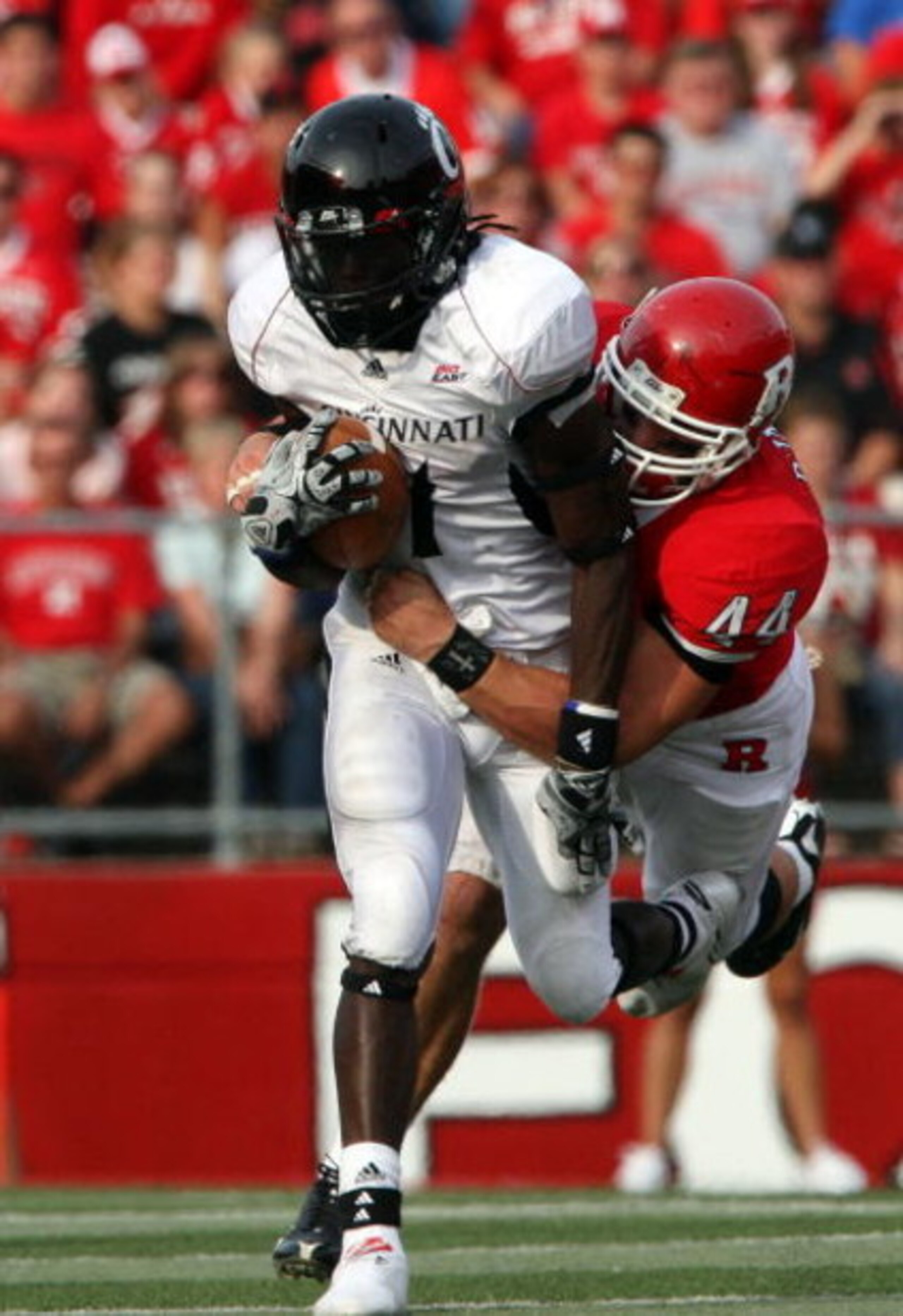 PISCATAWAY, NJ - SEPTEMBER 07:  Ryan D'Imperio #44 of the Rutgers Scarlet Knights tackles Mardy Gilyard #1 of the Cincinnati Bearcats at Rutgers Stadium on September 7, 2009 in Piscataway, New Jersey.  (Photo by Jim McIsaac/Getty Images)