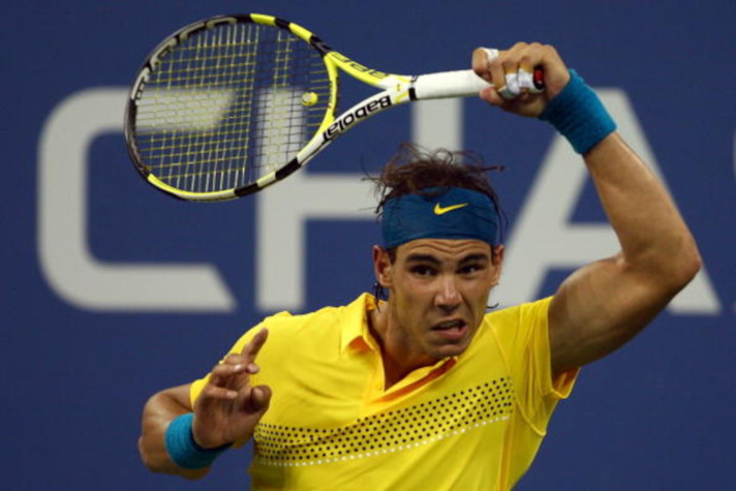 NEW YORK - SEPTEMBER 08:  Rafael Nadal of Spain returns a shot to  Gael Monfils of France during day nine of the 2009 U.S. Open at the USTA Billie Jean King National Tennis Center on September 8, 2009 in the Flushing neighborhood of the Queens borough of 
