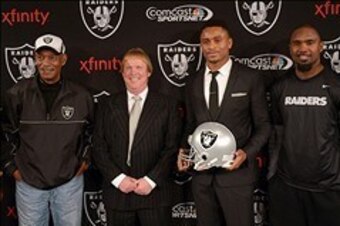 Dec 27, 2013; Alameda, CA, USA; Oakland Raiders former cornerback Nnamdi Asomugha poses at press conference to announce his retirement at Oakland Raiders Practice Facility. From left: Willie Brown and Mark Davis and Asomugha and Charles Woodson and Cliff 