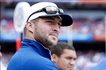 Nov 30, 2013; Gainesville, FL, USA; Florida Gators former player Tim Tebow (15) watches from the sidelines during the first quarter against the Florida State Seminoles at Ben Hill Griffin Stadium. Mandatory Credit: Kim Klement-USA TODAY Sports