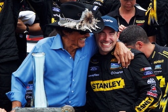 WATKINS GLEN, NY - AUGUST 12:  Marcos Ambrose, driver of the #9 Stanley Ford, celebrates with team owner Richard Petty in Victory Lane after winning the NASCAR Sprint Cup Series Finger Lakes 355 at the Glen at Watkins Glen International on August 12, 2012