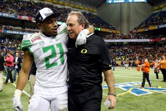 SAN ANTONIO, TX - DECEMBER 30: Cornerback Avery Patterson #21 of the Oregon Ducks celebrates on the field with defensive coordinator Nick Aliotti after defeating the Texas Longhorns 30-7 in the Valero Alamo Bowl at the Alamodome on December 30, 2013 in Sa
