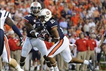 Oct 5, 2013; Auburn, AL, USA; Auburn Tigers quarterback Nick Marshall (14) hands off the ball to running back Tre Mason (21) for a touchdown against the Mississippi Rebels in the first quarter at Jordan Hare Stadium. Mandatory Credit: Shanna Lockwood-USA 