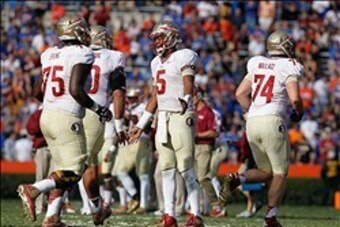 Nov 30, 2013; Gainesville, FL, USA; Florida State Seminoles quarterback Jameis Winston (5) high fives teammates after they scored against the Florida Gators during the second half at Ben Hill Griffin Stadium. Florida State Seminoles defeated the Florida G