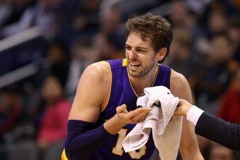 PHOENIX, AZ - DECEMBER 23:  Pau Gasol #16 of the Los Angeles Lakers reacts after being cut near his right eye during the second half of the NBA game against the Phoenix Suns at US Airways Center on December 23, 2013 in Phoenix, Arizona. The Suns defeated 