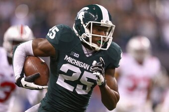 INDIANAPOLIS, IN - DECEMBER 07:  Keith Mumphery #25 of the Michigan State Spartans runs for a touchdown against the Ohio State Buckeyes in the second quarter of the Big Ten Conference Championship game at Lucas Oil Stadium on December 7, 2013 in Indianapo