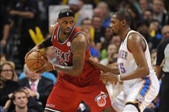 Feb 14, 2013; Oklahoma City, OK, USA; Miami Heat forward LeBron James (6) handles the ball against Oklahoma City Thunder forward Kevin Durant (35) during the second half at the Chesapeake Energy Arena.  Mandatory Credit: Mark D. Smith-USA TODAY Sports