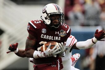 ORLANDO, FL - JANUARY 01:  Bruce Ellington  #23 of the South Carolina Gamecocks hauls in a 39 yard touchdown pass during the first half of their game against the Wisconsin Badgers at the Capital One Bowl on January 1, 2014 in Orlando, Florida.  (Photo by 