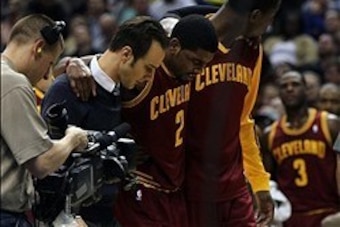 Dec 31, 2013; Indianapolis, IN, USA;  Cleveland Cavaliers point guard Kyrie Irving (2) is helped off the court after being injured during the third quarter against the Indiana Pacers at Bankers Life Fieldhouse. The Pacers won 91-76.  Mandatory Credit: Pat