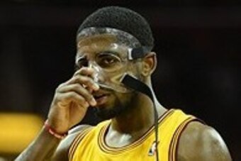 Nov 20, 2013; Cleveland, OH, USA; Cleveland Cavaliers point guard Kyrie Irving (2) adjusts his protective face mask during the game against the Washington Wizards at Quicken Loans Arena. Mandatory Credit: Eric P. Mull-USA TODAY Sports