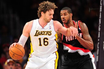 December 1, 2013; Los Angeles, CA, USA; Los Angeles Lakers center Pau Gasol (16) moves the ball against the defense of Portland Trail Blazers power forward LaMarcus Aldridge (12) during the first half at Staples Center. Mandatory Credit: Gary A. Vasquez-U