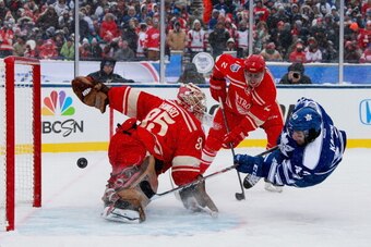 ANN ARBOR, MI - JANUARY 01:  Goaltender Jimmy Howard #35 of the Detroit Red Wings makes a save on a scoring attempt by Nazem Kadri #43 of the Toronto Maple Leafs in the second period during the 2014 Bridgestone NHL Winter Classic on January 1, 2014 at Mic