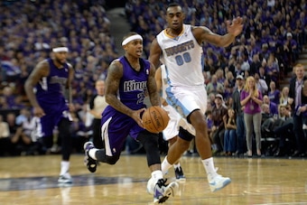 SACRAMENTO, CA - OCTOBER 30:  Isaiah Thomas #22 of the Sacramento Kings drives past Darrell Arthur #00 of the Denver Nuggets during the third quarter at Sleep Train Arena on October 30, 2013 in Sacramento, California. The Kings won the game 90-88  NOTE TO