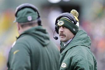 GREEN BAY, WI - NOVEMBER 24:  Aaron Rodgers #12 of the Green Bay Packers talks with Coach Mike McCarthy on the sidelines against the Minnesota Vikings defense at Lambeau Field on November 24, 2013 in Green Bay, Wisconsin.  (Photo Tom Lynn /Getty Images)