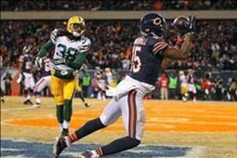 Dec 29, 2013; Chicago, IL, USA; Chicago Bears wide receiver Brandon Marshall (15) catches a touchdown pass with Green Bay Packers cornerback Tramon Williams (38) defending during the second half at Soldier Field. Green Bay won 33-28. Mandatory Credit: Den