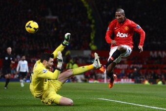 MANCHESTER, ENGLAND - JANUARY 01:   Hugo Lloris of Tottenham Hotspur blocks the attempt on goal of Ashley Young of Manchester United  during the Barclays Premier League match between Manchester United and Tottenham Hotspur at Old Trafford on January 1, 20