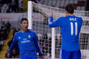 MADRID, SPAIN - NOVEMBER 02:  Cristiano Ronaldo of Real Madrid CF celebrates scoring his team's third goal with team mate Gareth Bale during the La Liga match between Rayo Vallecano de Madrid and Real Madrid CF  at Estadio de Vallecas on November 2, 2013 