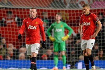 MANCHESTER, ENGLAND - JANUARY 01:  Wayne Rooney of Manchester United and his team-mate Nemanja Vidic (r) react after conceding a second goal during the Barclays Premier League match between Manchester United and Tottenham Hotspur at Old Trafford on Januar