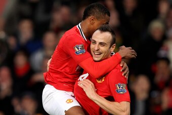 MANCHESTER, ENGLAND - DECEMBER 26:  Dimitar Berbatov of Manchester United celebrates scoring with team mate Patrice Evra (L) during the Barclays Premier League match between Manchester United and Wigan Athletic at Old Trafford on December 26, 2011 in Manc