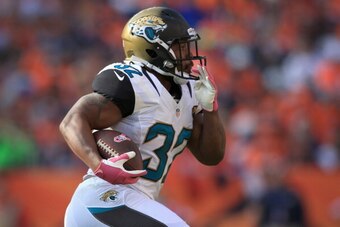 DENVER, CO - OCTOBER 13:  Running back Maurice Jones-Drew #32 of the Jacksonville Jaguars carries the ball against the Denver Broncos at Sports Authority Field at Mile High on October 13, 2013 in Denver, Colorado. The Broncos defeated the Jaguars 35-19.  