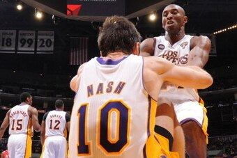 LOS ANGELES, CA - MARCH 3: Steve Nash #10 of the Los Angeles Lakers is helped up by teammate Kobe Bryant #24 during their game against the Atlanta Hawks at Staples Center on March 3, 2013 in Los Angeles, California. NOTE TO USER: User expressly acknowledg