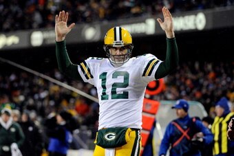 CHICAGO, IL - DECEMBER 29: Quarterback Aaron Rodgers #12 of the Green Bay Packers celebrates a touchdown against the Chicago Bears in the second quarter during a game at Soldier Field on December 29, 2013 in Chicago, Illinois.  (Photo by David Banks/Getty