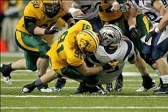 Dec 20, 2013; Fargo, ND, USA; New Hampshire Wildcats quarterback Sean Goldrich (5) is sacked by North Dakota State Bison defensive end Mike Hardie (91) during the fourth quarter at FargoDome. North Dakota State defeated New Hampshire 52-14. Mandatory Cred