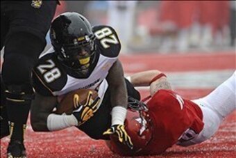 Dec 21, 2013; Cheney, WA, USA; Towson Tigers running back Terrance West (28) is brought down by Eastern Washington Eagles linebacker Ronnie Hamlin (39) during the first half at Roos Field. Mandatory Credit: James Snook-USA TODAY Sports