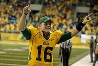 Dec 20, 2013; Fargo, ND, USA; North Dakota State Bison quarterback Brock Jensen (16) celebrates during the fourth quarter against the New Hampshire Wildcats at FargoDome. North Dakota State defeated New Hampshire 52-14. Mandatory Credit: Brace Hemmelgarn-