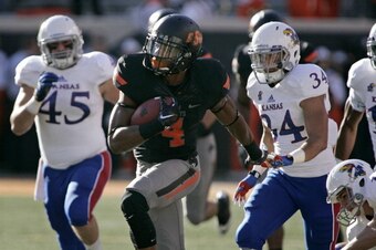 STILLWATER, OK - NOVEMBER 9:   Cornerback Justin Gilbert #4 of the Oklahoma State Cowboys runs downfield for a touchdown on the opening kickoff against the Kansas Jayhawks Novemeber 9, 2013 at Boone Pickens Stadium in Stillwater, Oklahoma.  (Photo by Bret