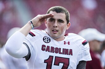 FAYETTEVILLE, AR - OCTOBER 12: Dylan Thompson #17 of the South Carolina Gamecocks salutes to someone in the crowd during a game against the Arkansas Razorbacks at Razorback Stadium on October 12, 2013 in Fayetteville, Arkansas. The Gamecocks defeated the 