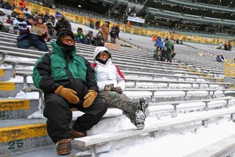 GREEN BAY, WI - DECEMBER 22:  Fans of the Green Bay Packers watch a game on the view screen before a game between the Packers and the Pittsburgh Steelers at Lambeau Field on December 22, 2013 in Green Bay, Wisconsin.  (Photo by Jonathan Daniel/Getty Image