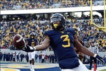 Nov 30, 2013; Morgantown, WV, USA; West Virginia Mountaineers running back Charles Sims (3) reacts after scoring a touchdown during the first quarter against the Iowa State Cyclones at Milan Puskar Stadium. Mandatory Credit: Tommy Gilligan-USA TODAY Sport