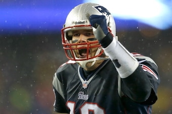 FOXBORO, MA - DECEMBER 29: Tom Brady #12 of the New England Patriots reacts after a touchdown by LeGarrette Blount during a game with the Buffalo Bills at Gillette Stadium on December 29, 2013 in Foxboro, Massachusetts. (Photo by Jim Rogash/Getty Images)