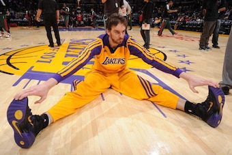 LOS ANGELES, CA - DECEMBER 31: Pau Gasol #16 of the Los Angeles Lakers stretches before a game against the Milwaukee Bucks at STAPLES Center on December 31, 2013 in Los Angeles, California. NOTE TO USER: User expressly acknowledges and agrees that, by dow
