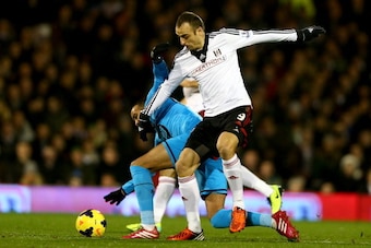 LONDON, ENGLAND - DECEMBER 04:  Sandro of Tottenham Hotspur battles with Dimitar Berbatov of Fulham during the Barclays Premier League match between Fulham and Tottenham Hotspur at Craven Cottage on December 4, 2013 in London, England.  (Photo by Paul Gil