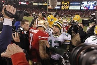 Jan 12, 2013; San Francisco, CA, USA; Green Bay Packers quarterback Aaron Rodgers (12) congratulates San Francisco 49ers quarterback Colin Kaepernick (7) after the NFC divisional round playoff game at Candlestick Park.  The 49ers defeated the Packers 45-3