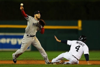 DETROIT, MI - OCTOBER 17:  Omar Infante #4 of the Detroit Tigers is out at second as Stephen Drew #7 of the Boston Red Sox turns a double play on a ball hit by Brayan Pena #55 in the fifth inning of Game Five of the American League Championship Series at 