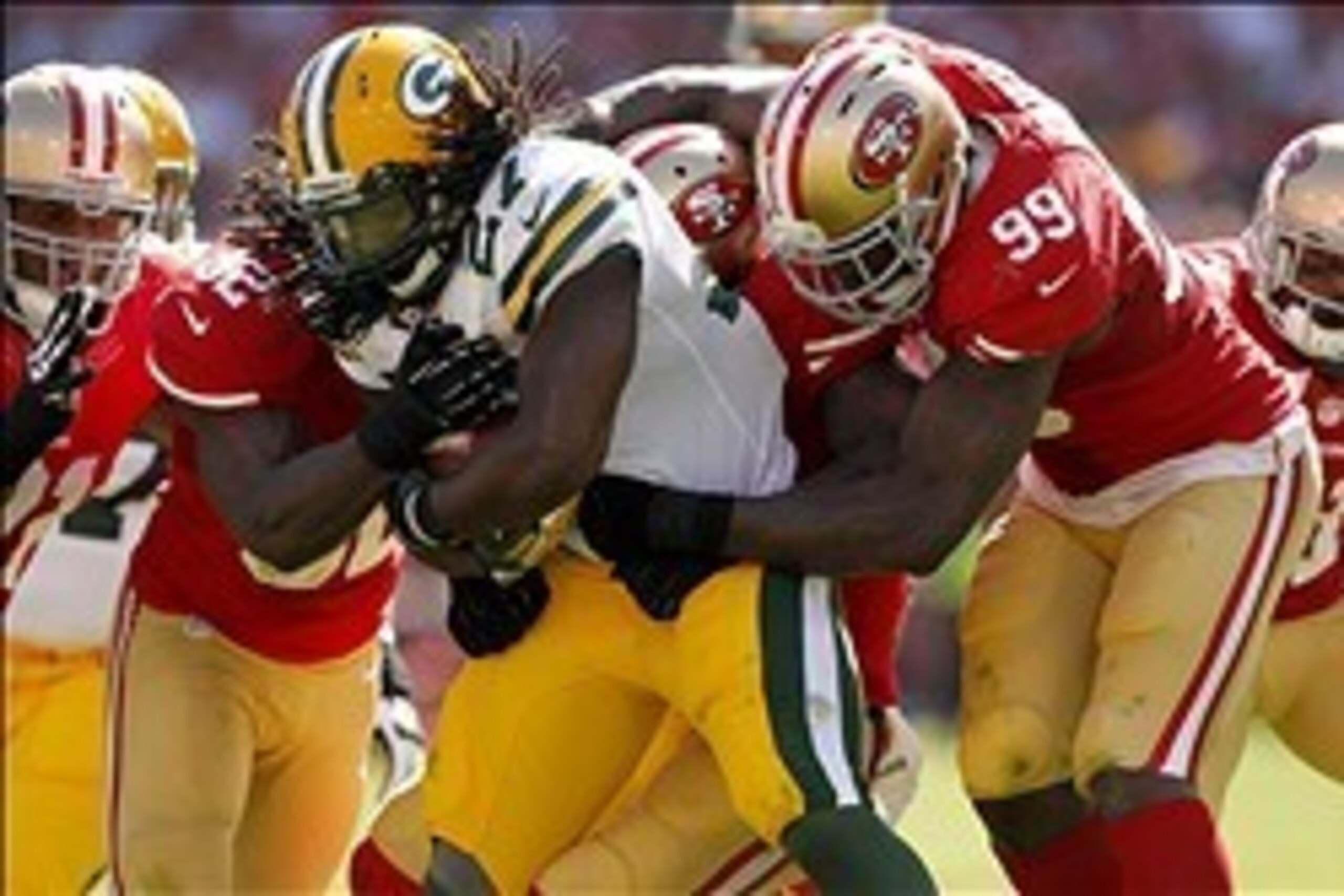 Sep 8, 2013; San Francisco, CA, USA; Green Bay Packers running back Eddie Lacy (27) is tackled by San Francisco 49ers linebacker Aldon Smith (99) and 49ers linebacker Patrick Willis (52) in the third quarter at Candlestick Park. The 49ers defeated the Pac