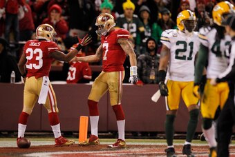 Jan 12, 2013; San Francisco, CA, USA; San Francisco 49ers quarterback Colin Kaepernick (7) is congratulated by running back LaMichael James (23) after scoring a touchdown against the Green Bay Packers during the third quarter of the NFC divisional round p