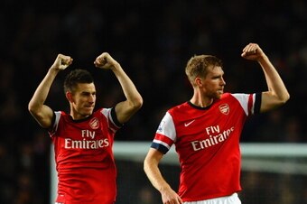 LONDON, ENGLAND - NOVEMBER 02:  Laurent Koscielny of Arsenal and Per Mertesacker of Arsenal celebrate victory at the final whistle during the Barclays Premier League match between Arsenal and Liverpool at Emirates Stadium on November 2, 2013 in London, En