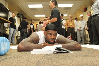 OKLAHOMA CITY, OK - JUNE 12: LeBron James #6 of the Miami Heat reads a book in the locker room prior to Game One of the 2012 NBA Finals against Oklahoma City Thunder at the Chesapeake Energy Arena on June 12, 2012 in Oklahoma City, Oklahoma. NOTE TO USER: